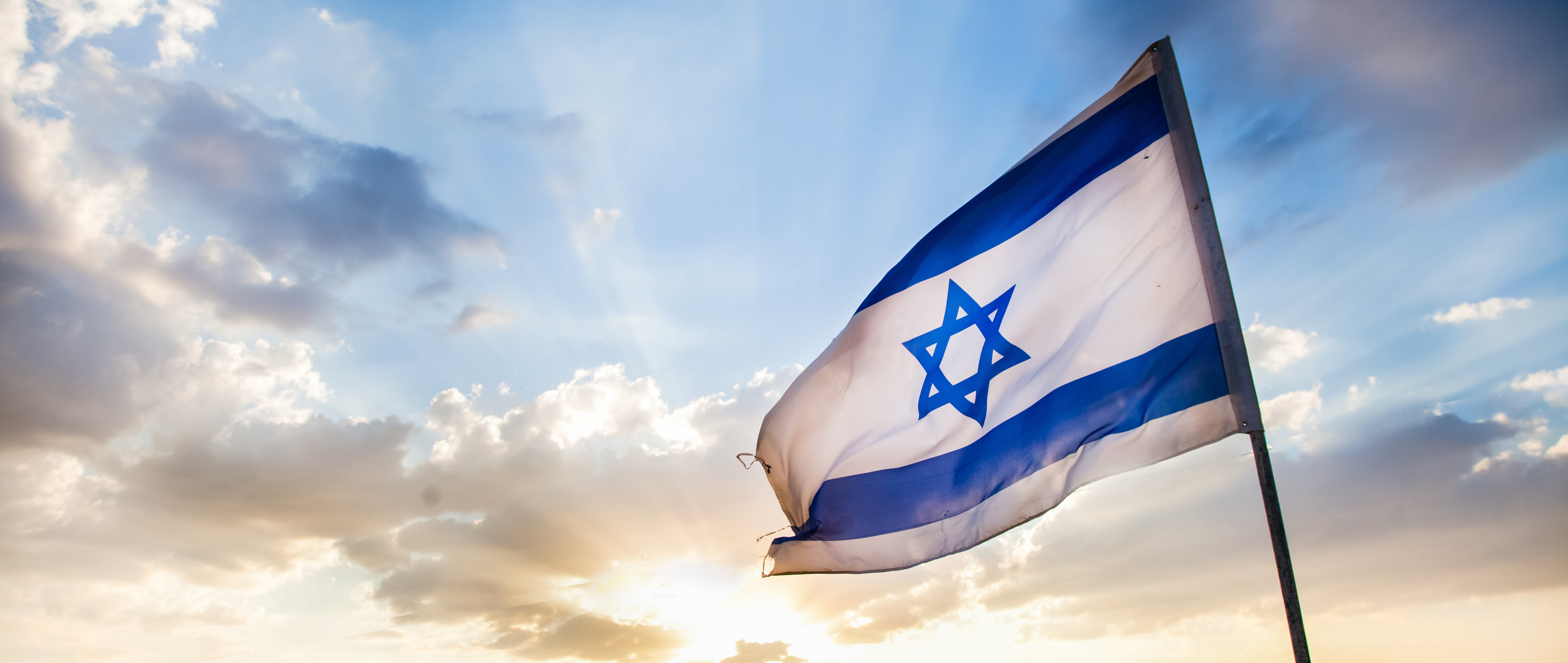 Israeli flag with a sunset